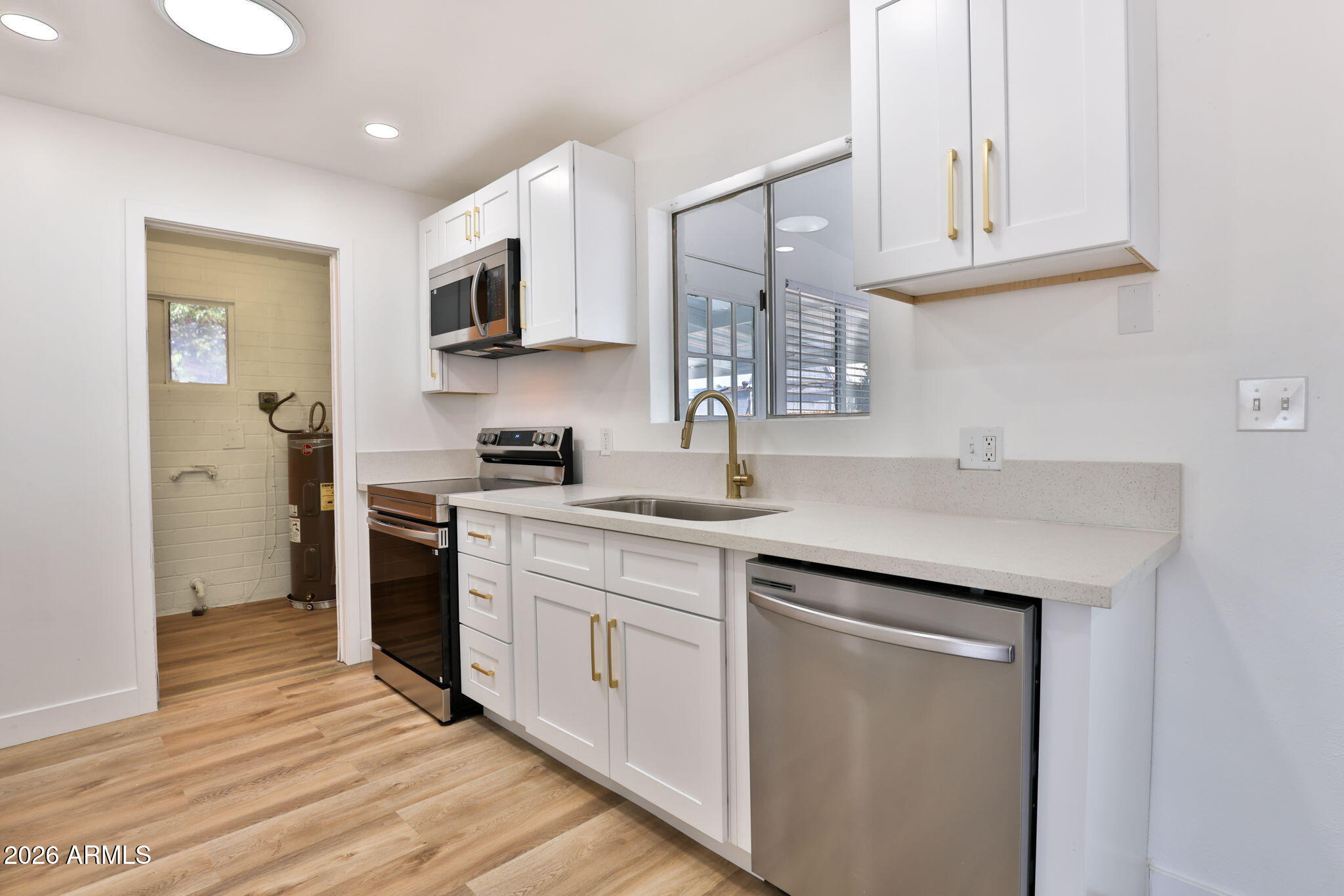 5510 East Dallas Street Mesa, AZ 85205 - Photo 7 of 24 a kitchen with a sink cabinets and stainless steel appliances