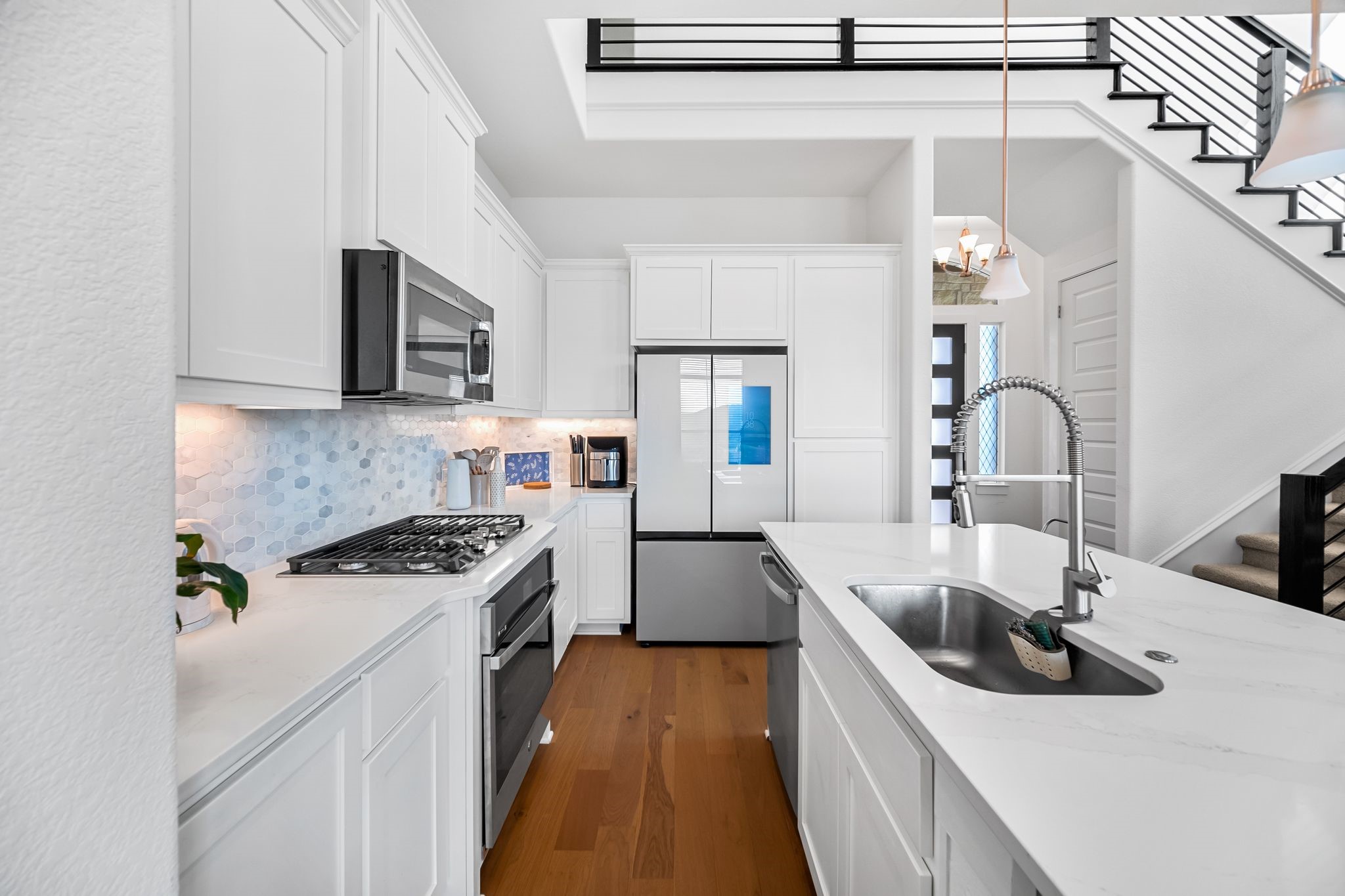 303 Cartwheel Bend Austin, TX 78738 - Photo 1 of 25 a kitchen with stainless steel appliances granite countertop a sink stove and refrigerator