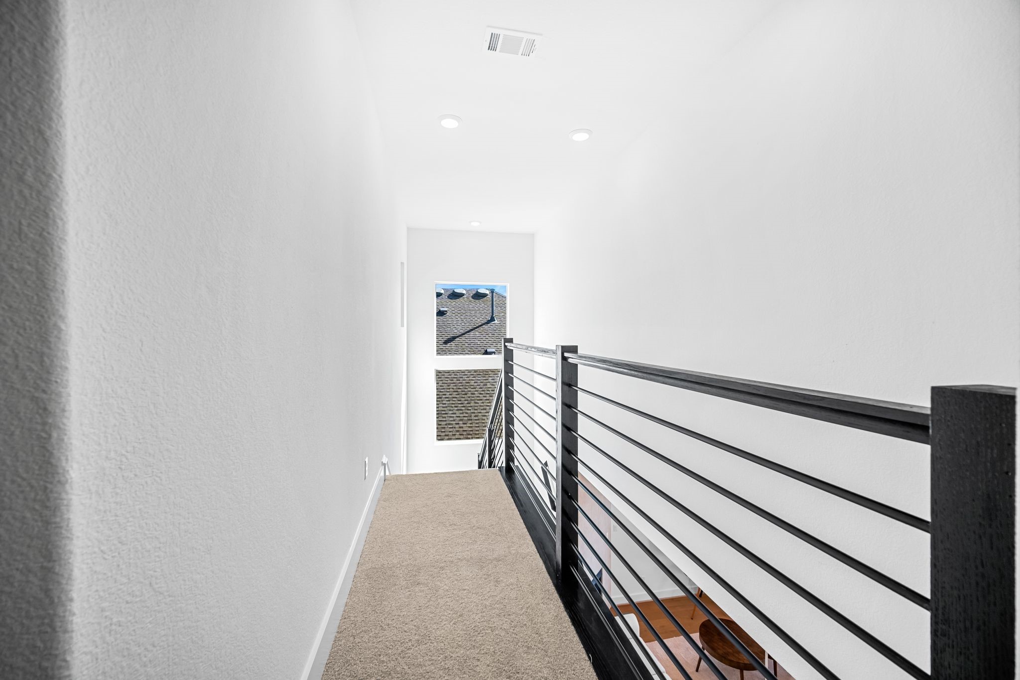 303 Cartwheel Bend Austin, TX 78738 - Photo 23 of 25 a view of a hallway with wooden floor and staircase