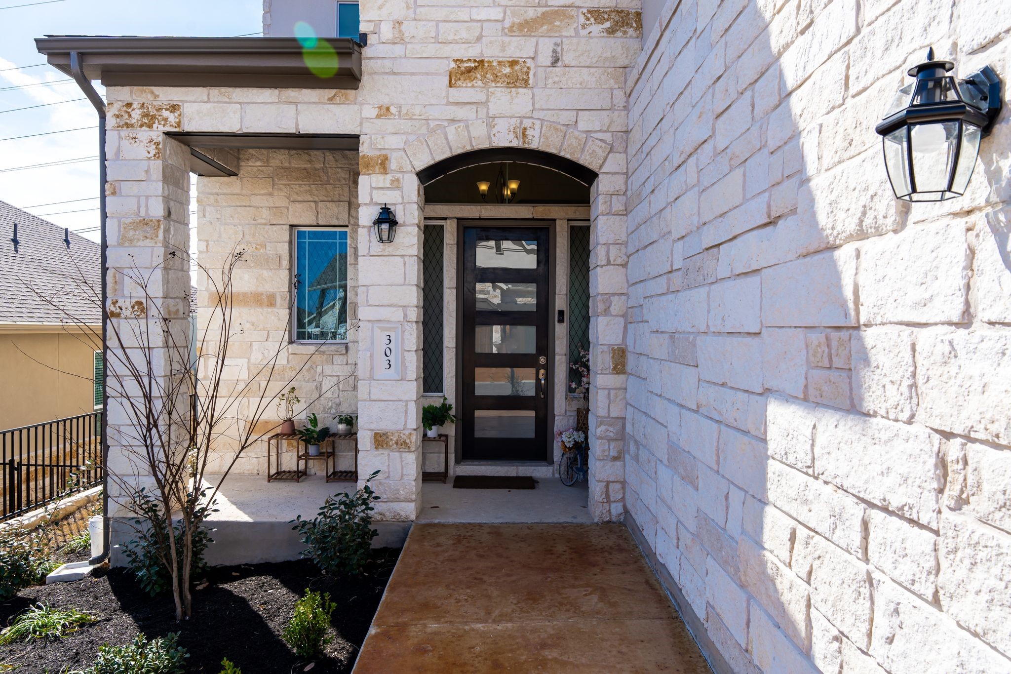 303 Cartwheel Bend Austin, TX 78738 - Photo 4 of 25 a view of a brick house with a large windows