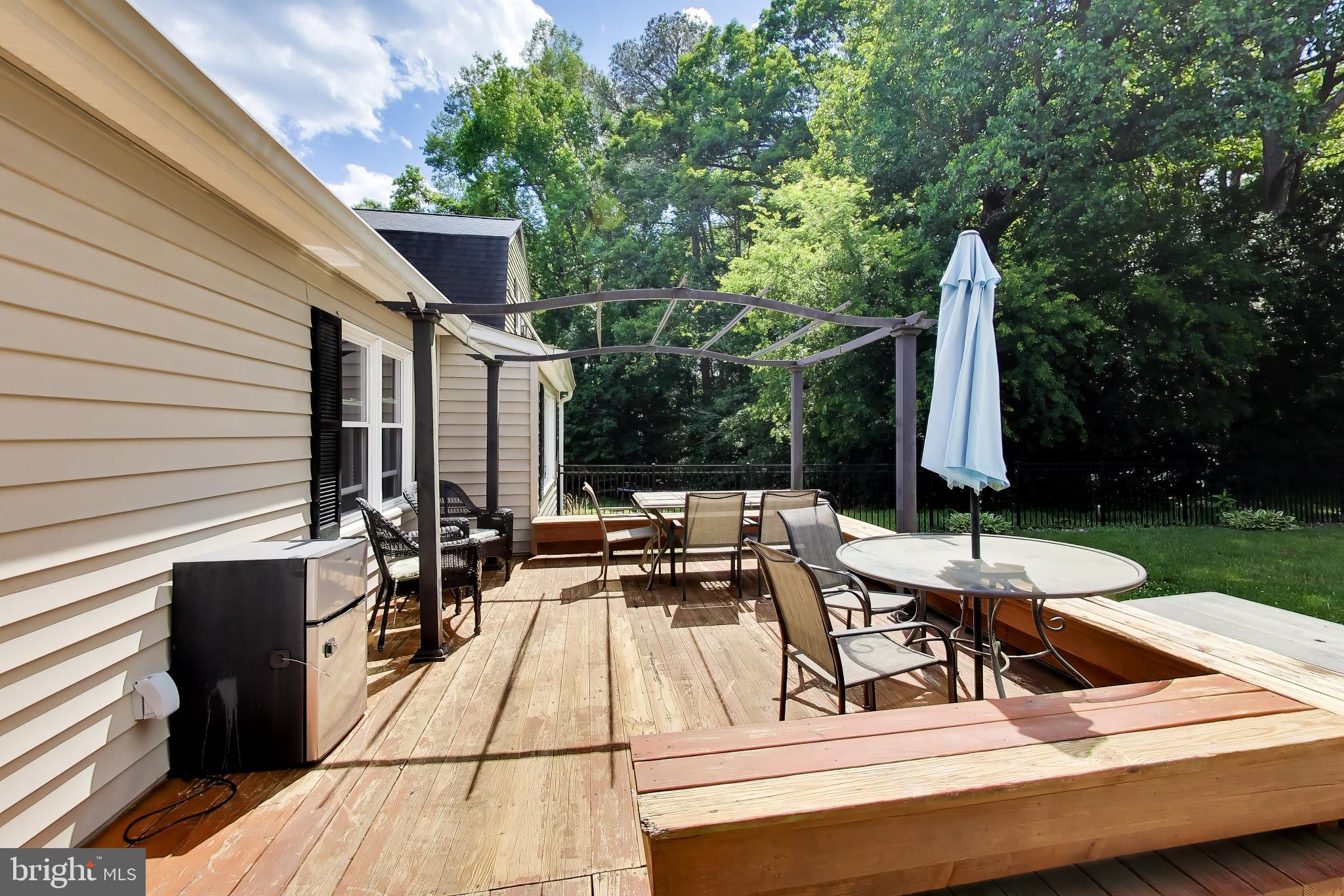 3240 Juniper Lane Huntingtown, MD 20639 - Photo 20 of 48 a view of a patio with couches table and chairs with plants and trees