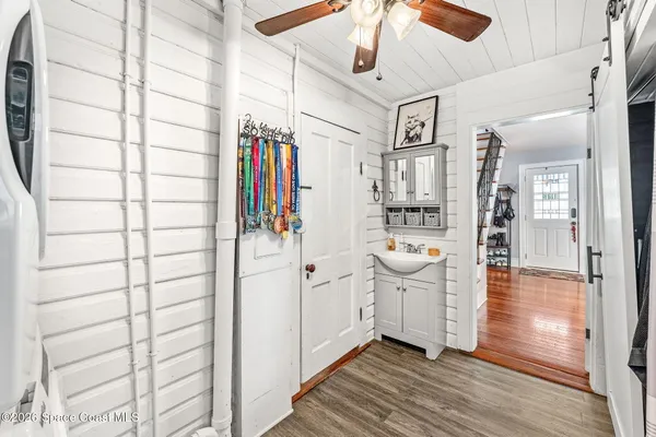 a view of a hallway and wooden floor
