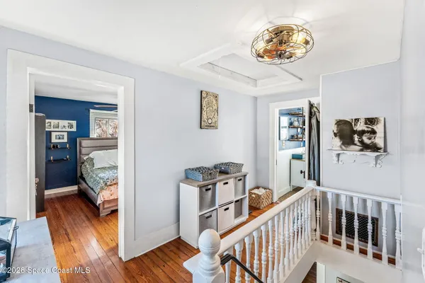 a view of a house with wooden deck and furniture