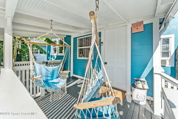 a view of a yard with plants and wooden fence
