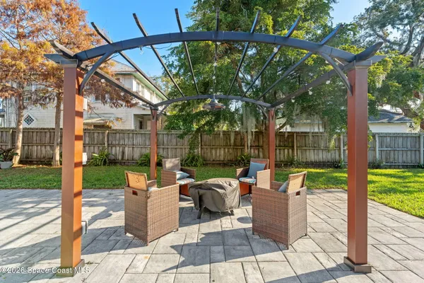 a view of a house with backyard and sitting area