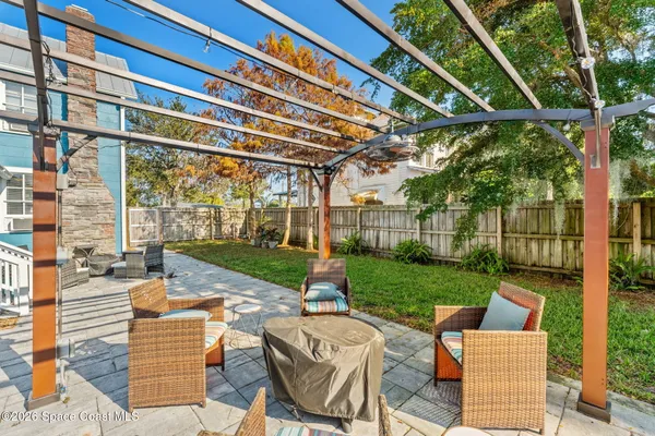 a view of a house with a yard patio and swimming pool
