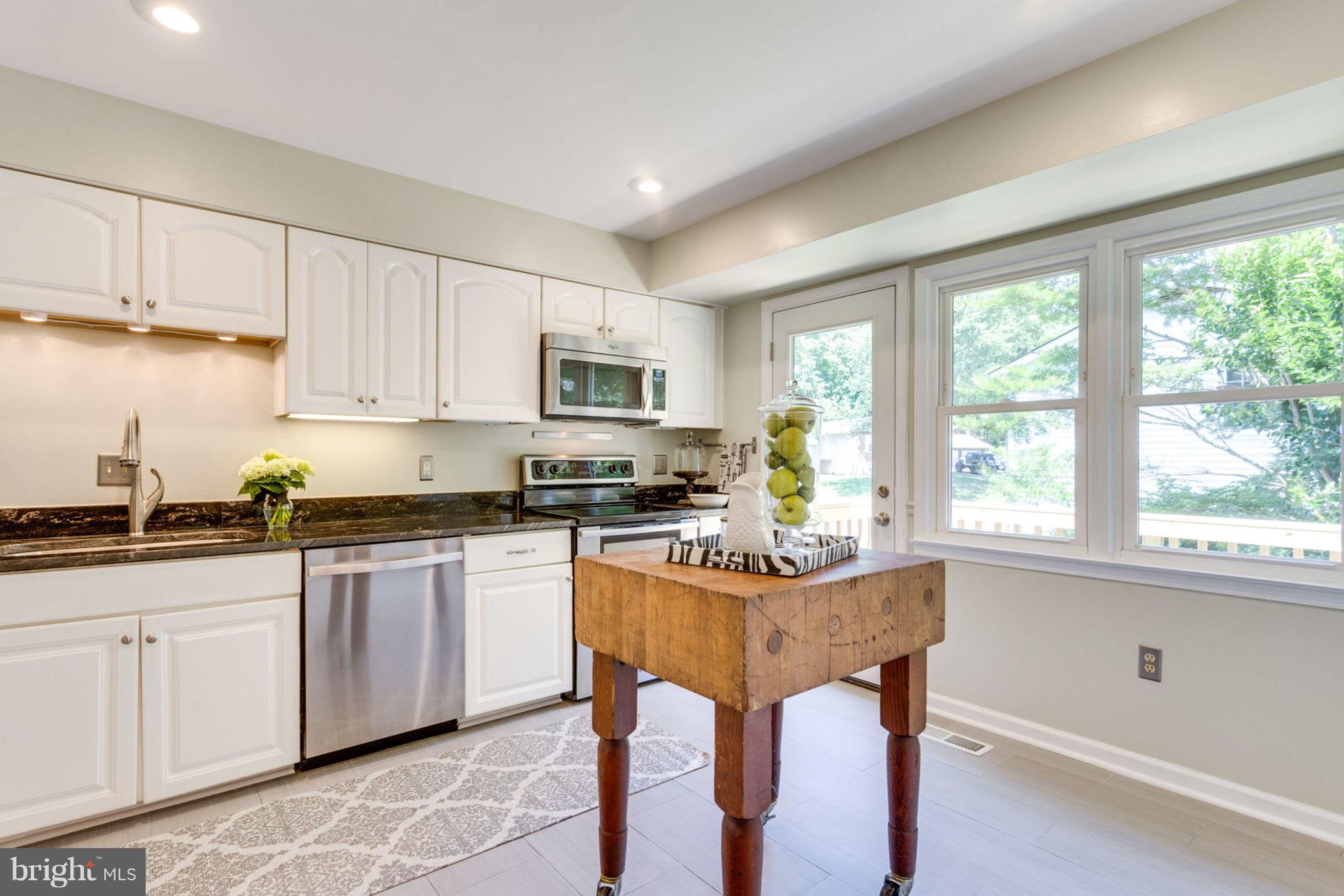 9147 Rockefeller Lane Springfield, VA 22153 - Photo 12 of 30 a kitchen with granite countertop white cabinets and white appliances