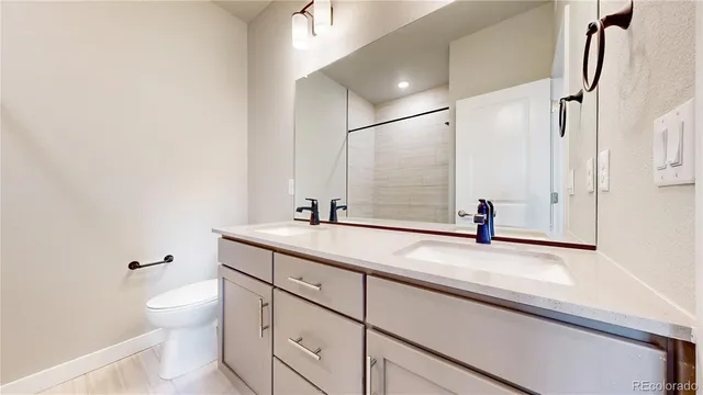 a bathroom with a sink toilet and mirror