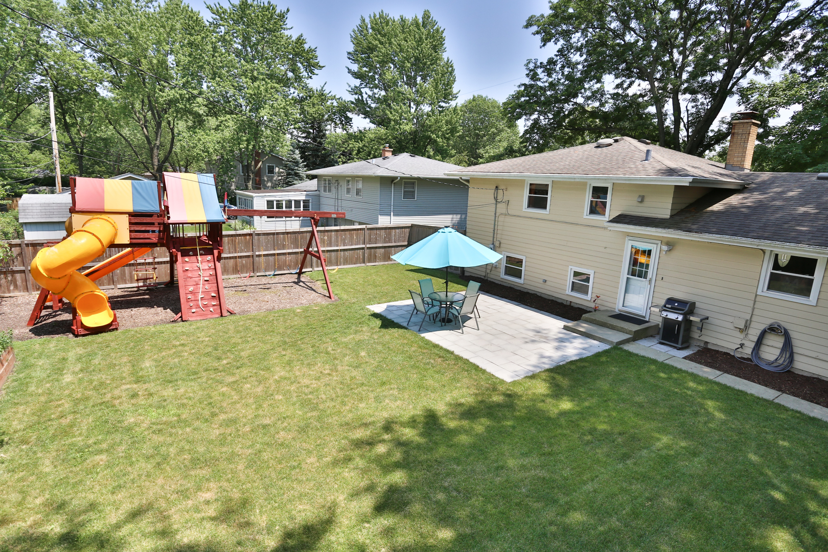 413 West Gartner Road Naperville, IL 60540 - Photo 20 of 22 a view of a house with backyard and sitting area