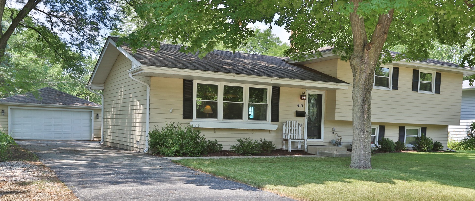 413 West Gartner Road Naperville, IL 60540 - Photo 3 of 22 a front view of a house with a yard and garage