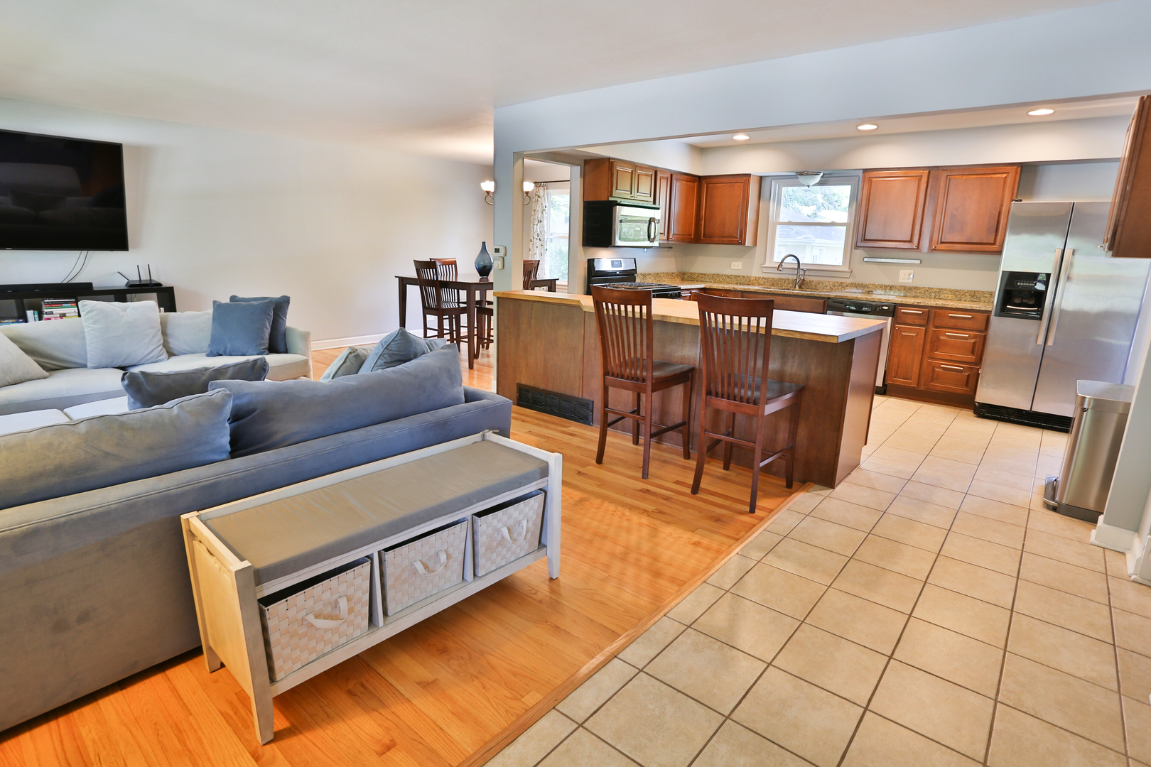 413 West Gartner Road Naperville, IL 60540 - Photo 4 of 22 a living room with stainless steel appliances kitchen island granite countertop a stove a sink a dining table and chairs