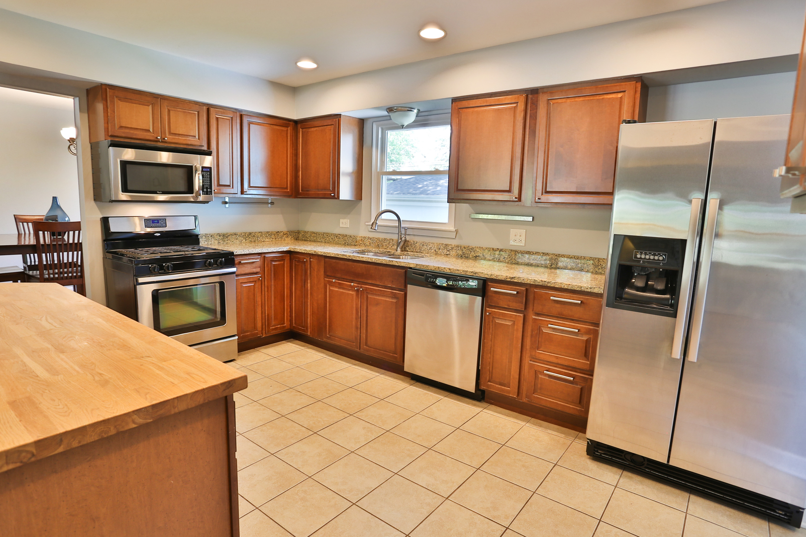 413 West Gartner Road Naperville, IL 60540 - Photo 7 of 22 a kitchen with stainless steel appliances granite countertop a stove top oven a sink dishwasher a refrigerator and a microwave