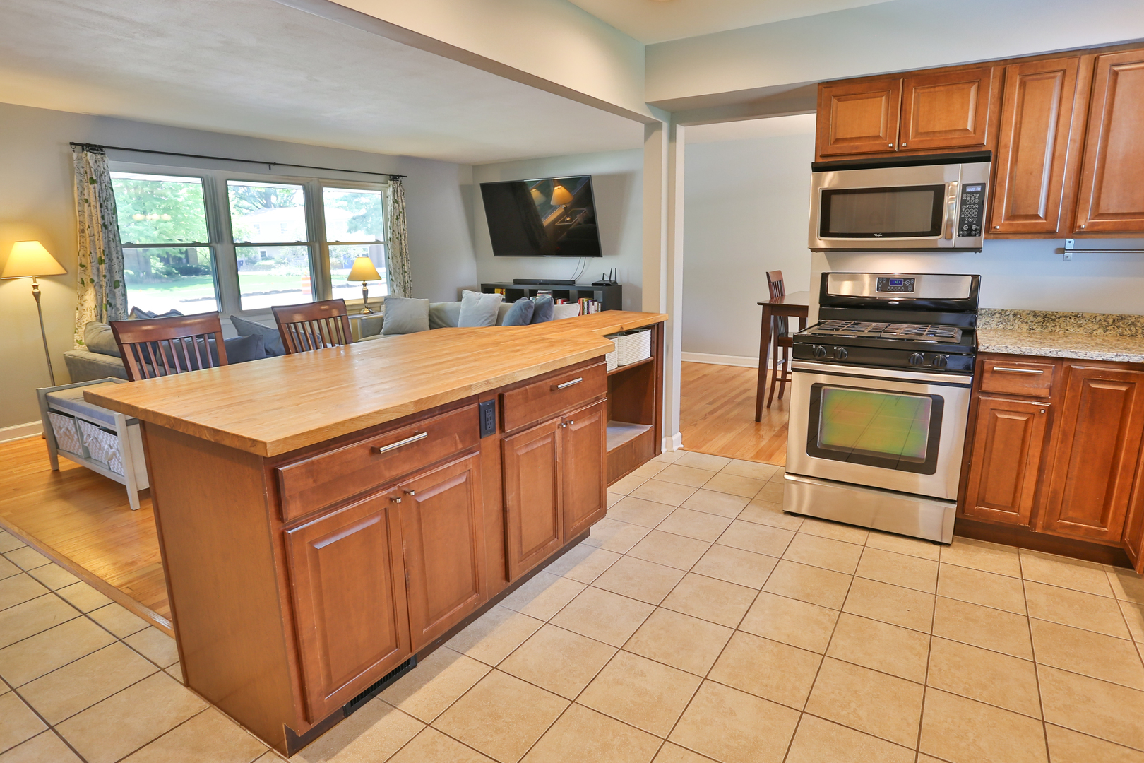 413 West Gartner Road Naperville, IL 60540 - Photo 8 of 22 a kitchen with stainless steel appliances granite countertop a stove microwave and a sink