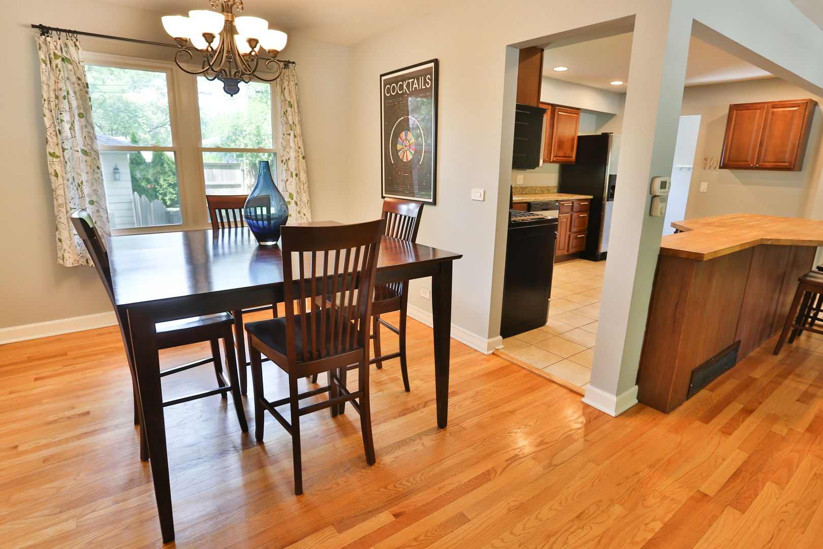 413 West Gartner Road Naperville, IL 60540 - Photo 9 of 22 a view of a dining room with furniture a chandelier and wooden floor