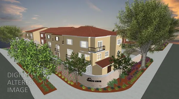 a view of a brick house with potted plants in front of it