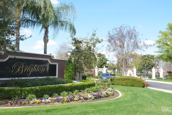 a front view of multi story residential apartment building with yard and green space