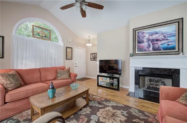 a living room with furniture a fireplace and a flat screen tv
