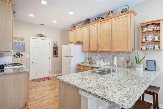 a kitchen with refrigerator cabinets and wooden floor