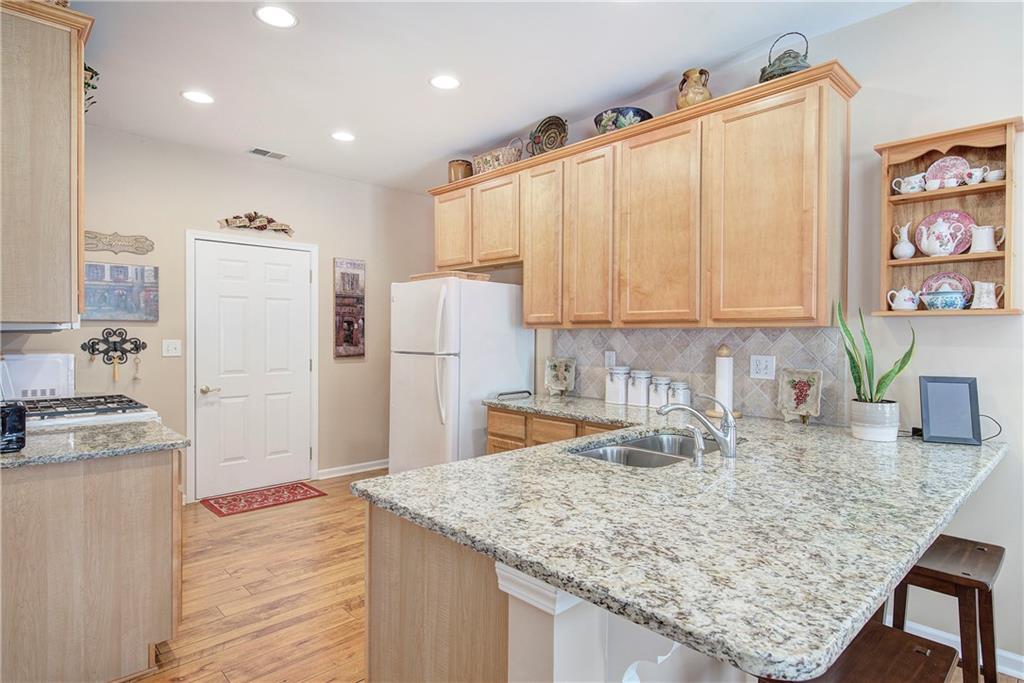 3383 Raes Creek Road, Unit 4 Marietta, GA 30008 - Photo 19 of 41 a kitchen with refrigerator cabinets and wooden floor