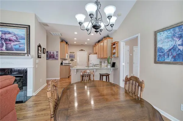 a view of a dining room with furniture and a chandelier