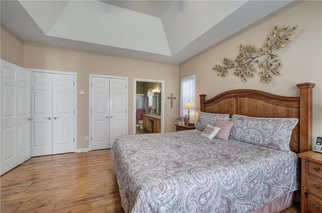 a bedroom with a bed and a mirror