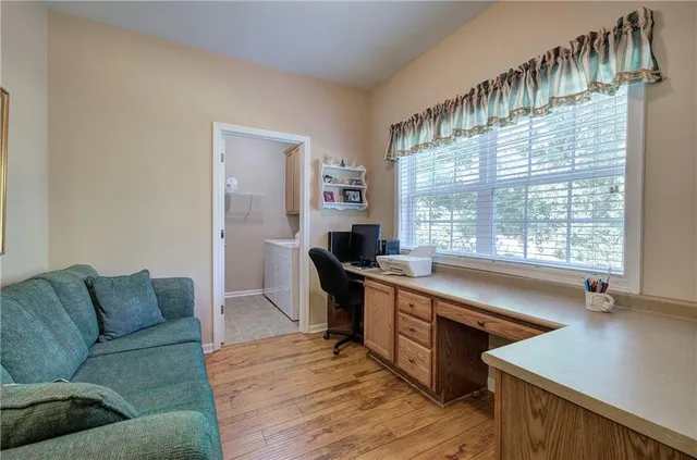 a living room with furniture and a large window