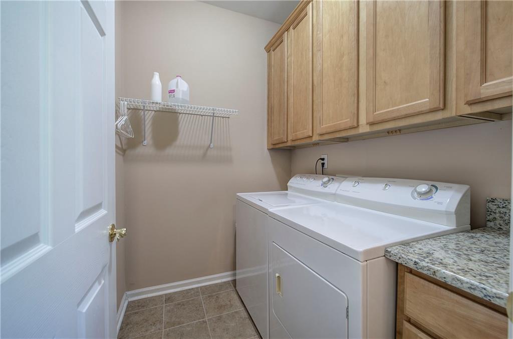 3383 Raes Creek Road, Unit 4 Marietta, GA 30008 - Photo 26 of 41 a utility room with cabinets washer and dryer