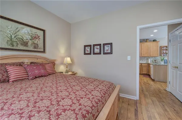 a bedroom with a large bed and a painting