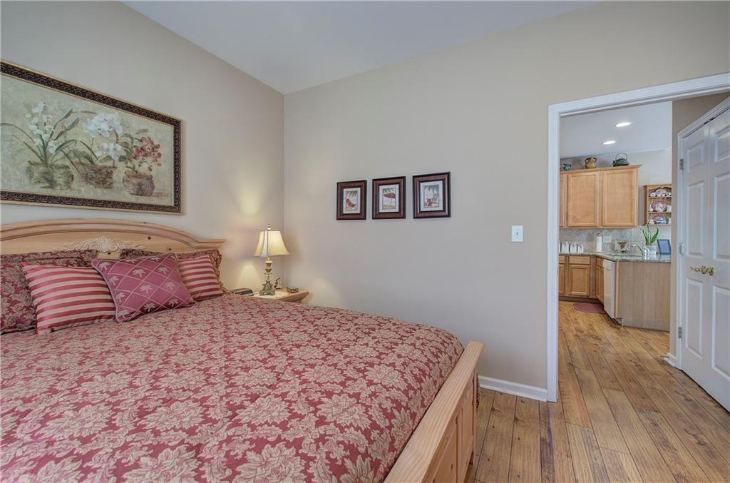 3383 Raes Creek Road, Unit 4 Marietta, GA 30008 - Photo 29 of 41 a bedroom with a large bed and a painting