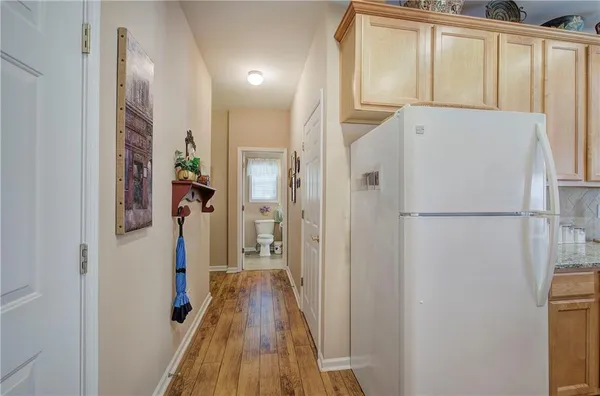 a view of a hallway with wooden floor and staircase