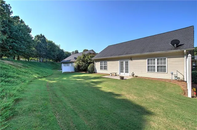a backyard of a house with table and chairs