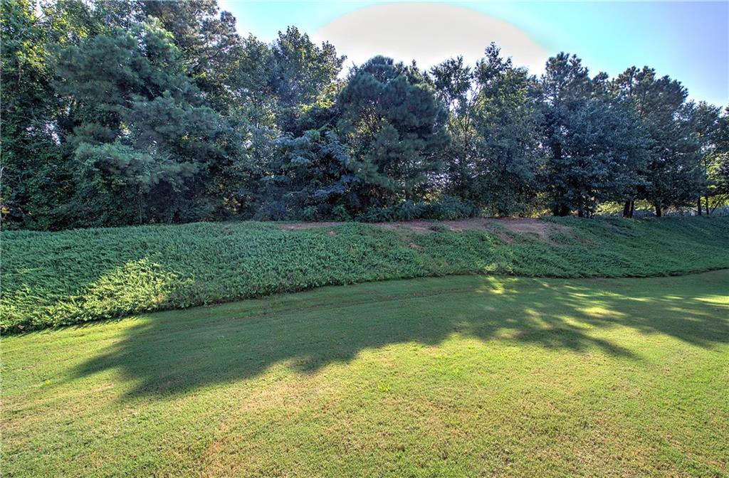 3383 Raes Creek Road, Unit 4 Marietta, GA 30008 - Photo 8 of 41 a view of a golf course with a lake