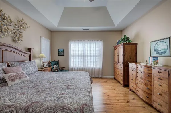 a spacious bedroom with a large bed and a dresser