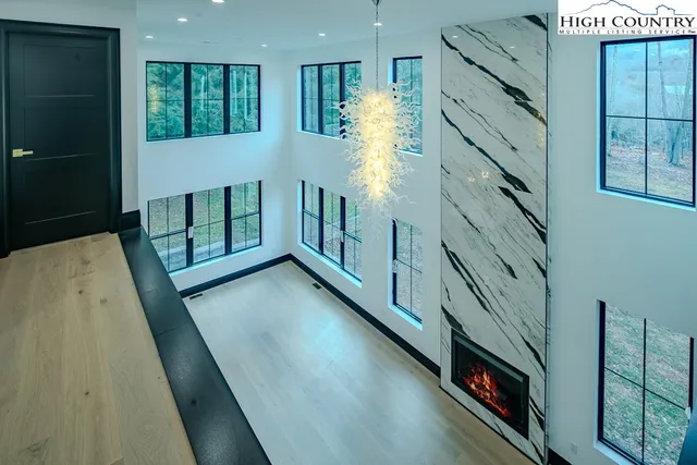 a view of an empty room with window and stairs