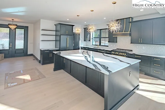 a kitchen with stainless steel appliances granite countertop a stove and a refrigerator