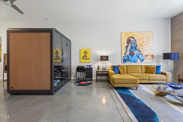a living room with furniture a flat screen tv and a rug