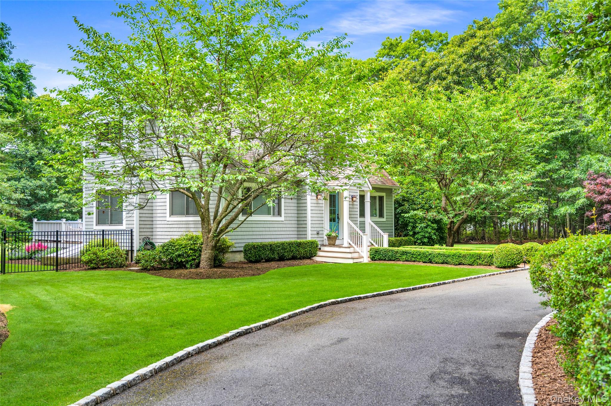 9 North Quarter Road Westhampton, NY 11977 - Photo 25 of 38 a front view of a house with a yard and trees