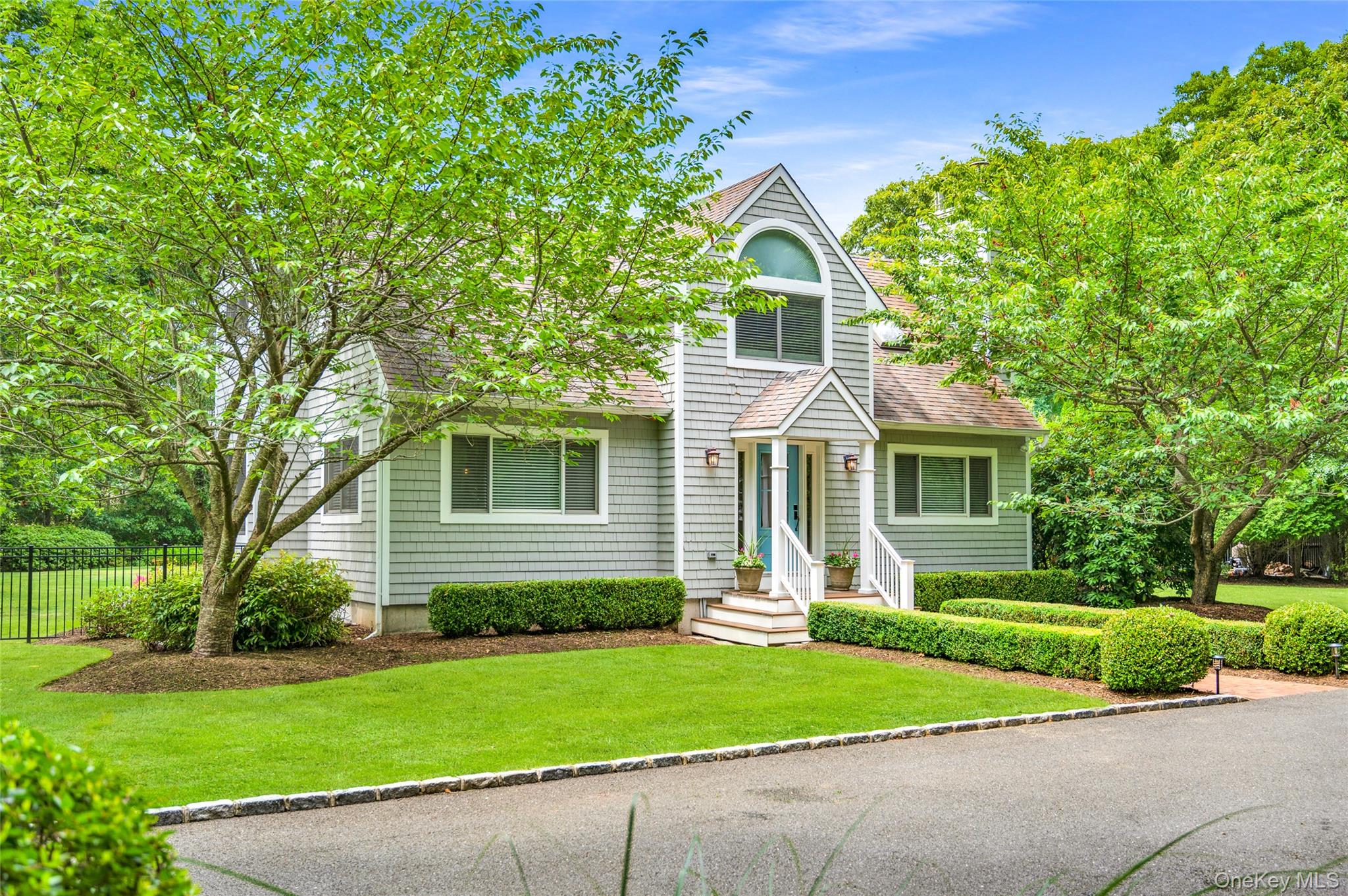 9 North Quarter Road Westhampton, NY 11977 - Photo 26 of 38 a front view of a house with a yard