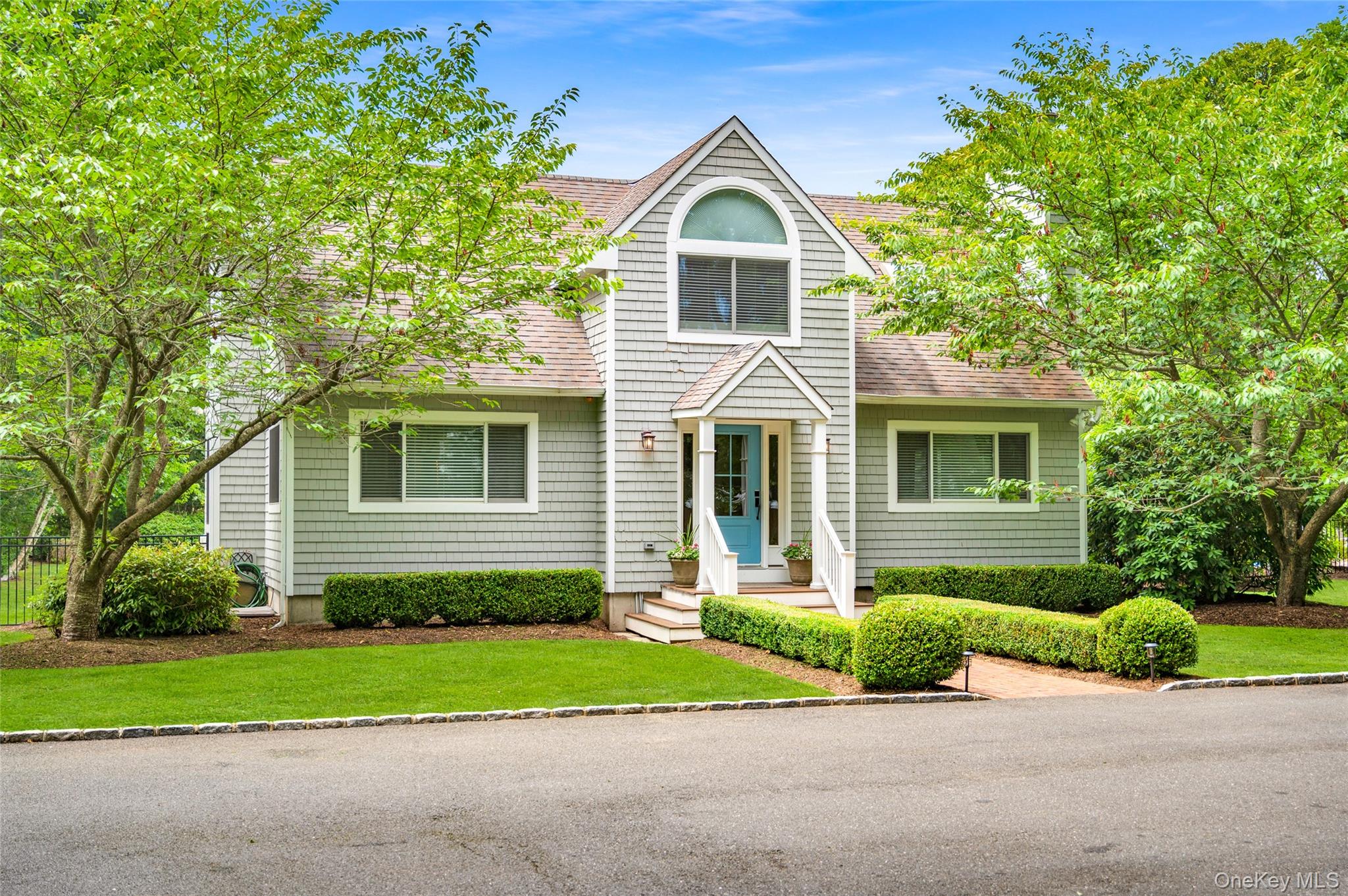 9 North Quarter Road Westhampton, NY 11977 - Photo 27 of 38 a front view of a house with a garden and trees