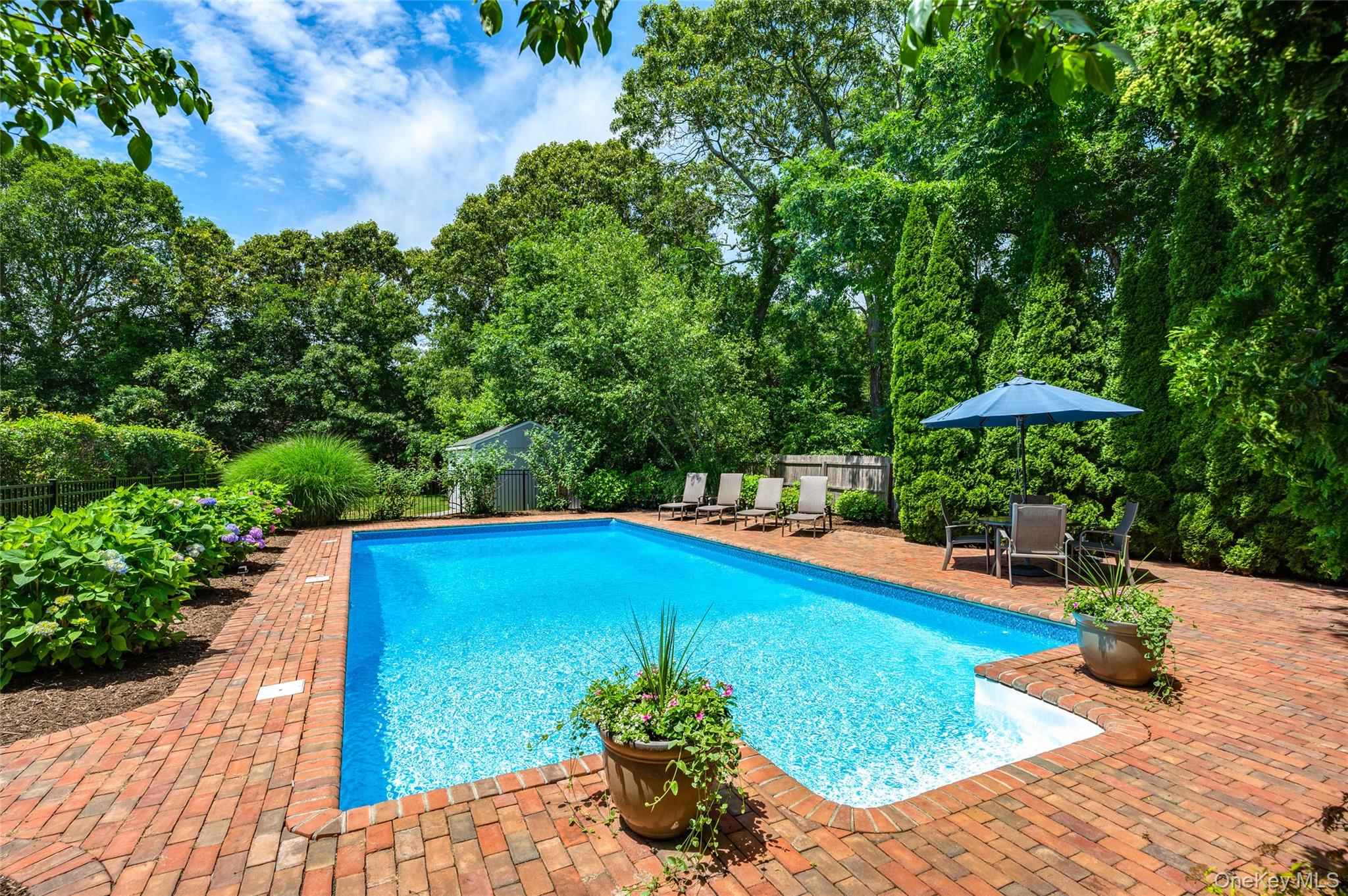 9 North Quarter Road Westhampton, NY 11977 - Photo 30 of 38 a view of a swimming pool with a patio