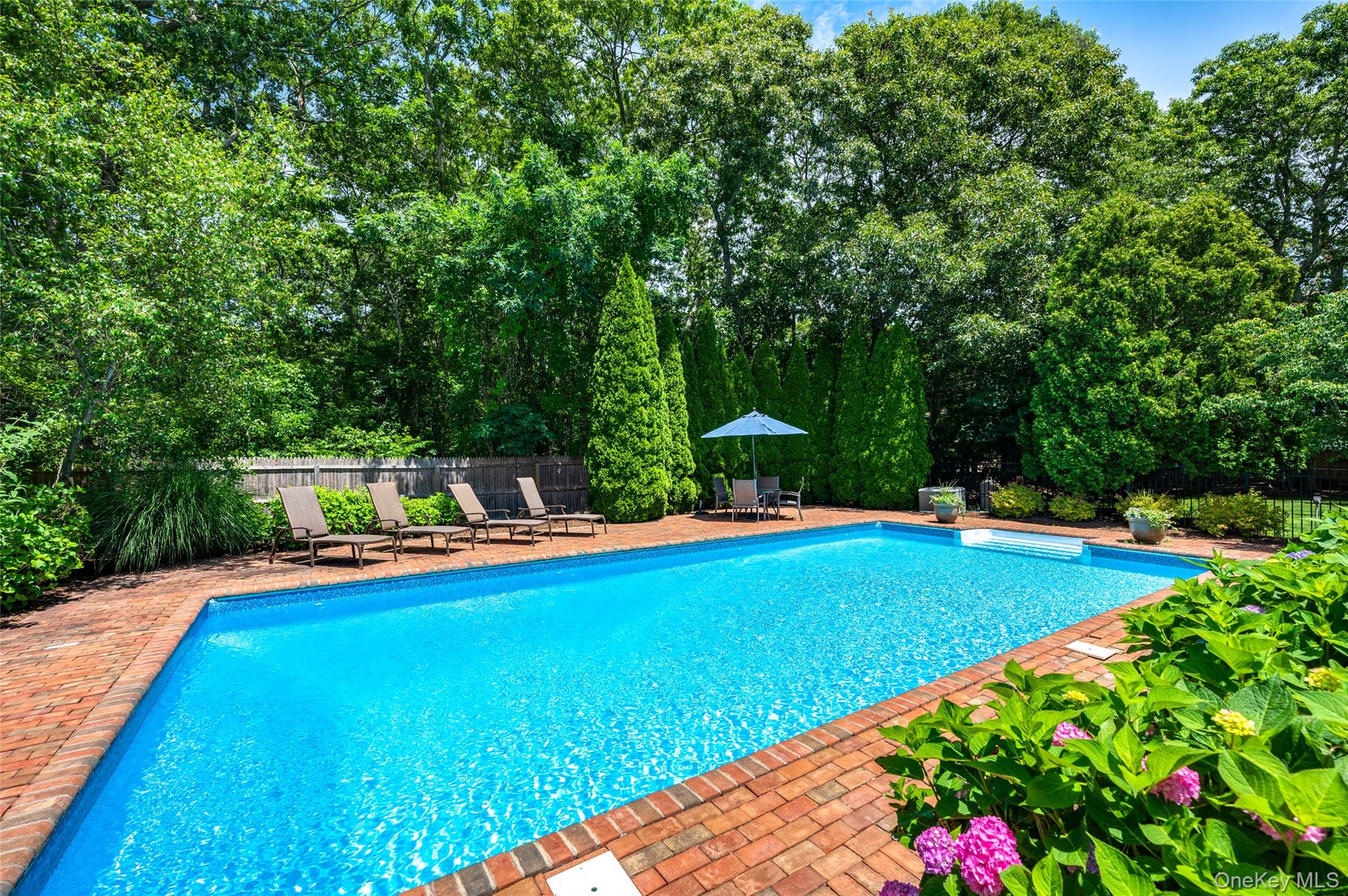9 North Quarter Road Westhampton, NY 11977 - Photo 31 of 38 a view of a swimming pool with a patio and a yard