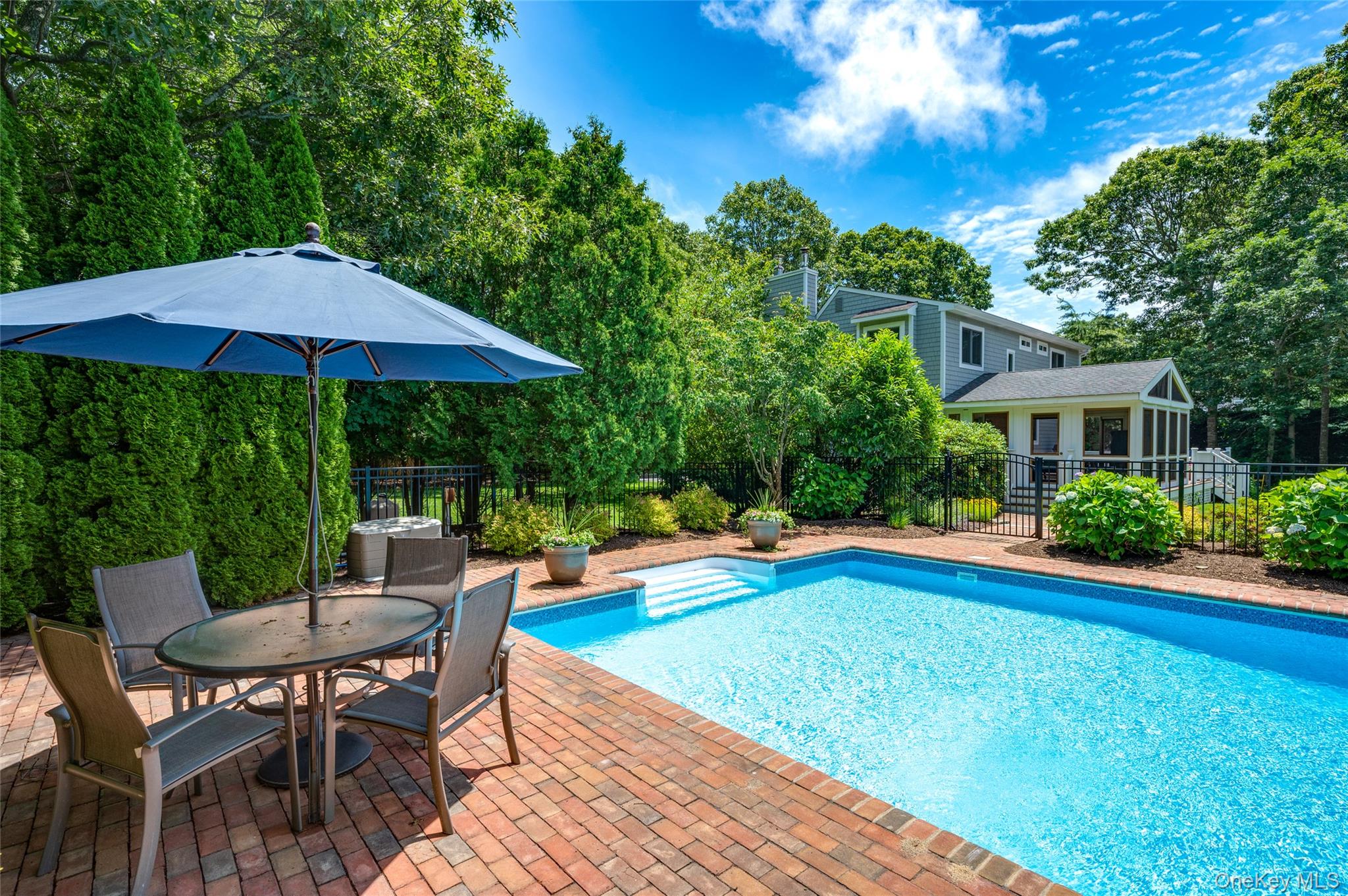 9 North Quarter Road Westhampton, NY 11977 - Photo 34 of 38 a view of pool with lawn chairs under an umbrella