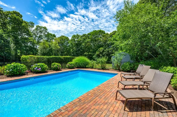a view of a swimming pool with lounge chair