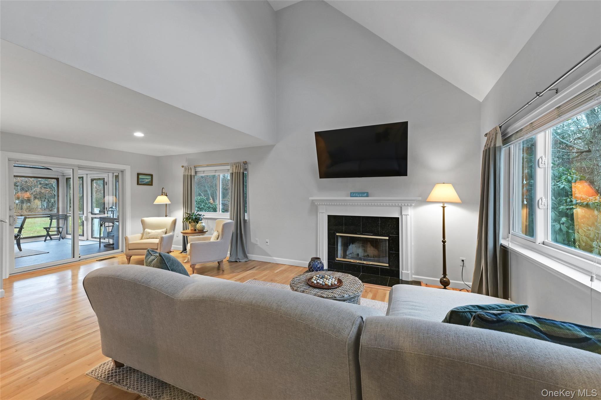 9 North Quarter Road Westhampton, NY 11977 - Photo 4 of 38 a living room with furniture a flat screen tv and a fireplace