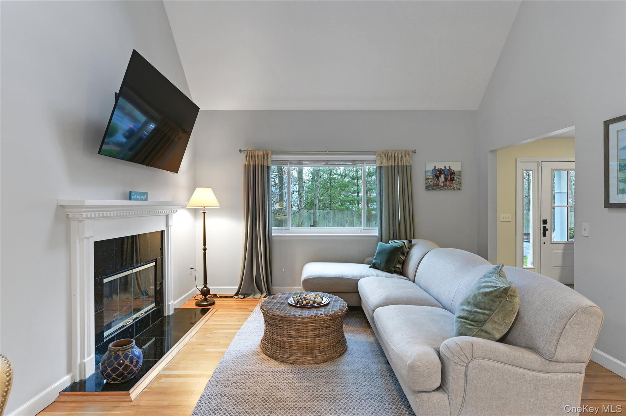 9 North Quarter Road Westhampton, NY 11977 - Photo 5 of 38 a living room with furniture a flat screen tv and a fireplace