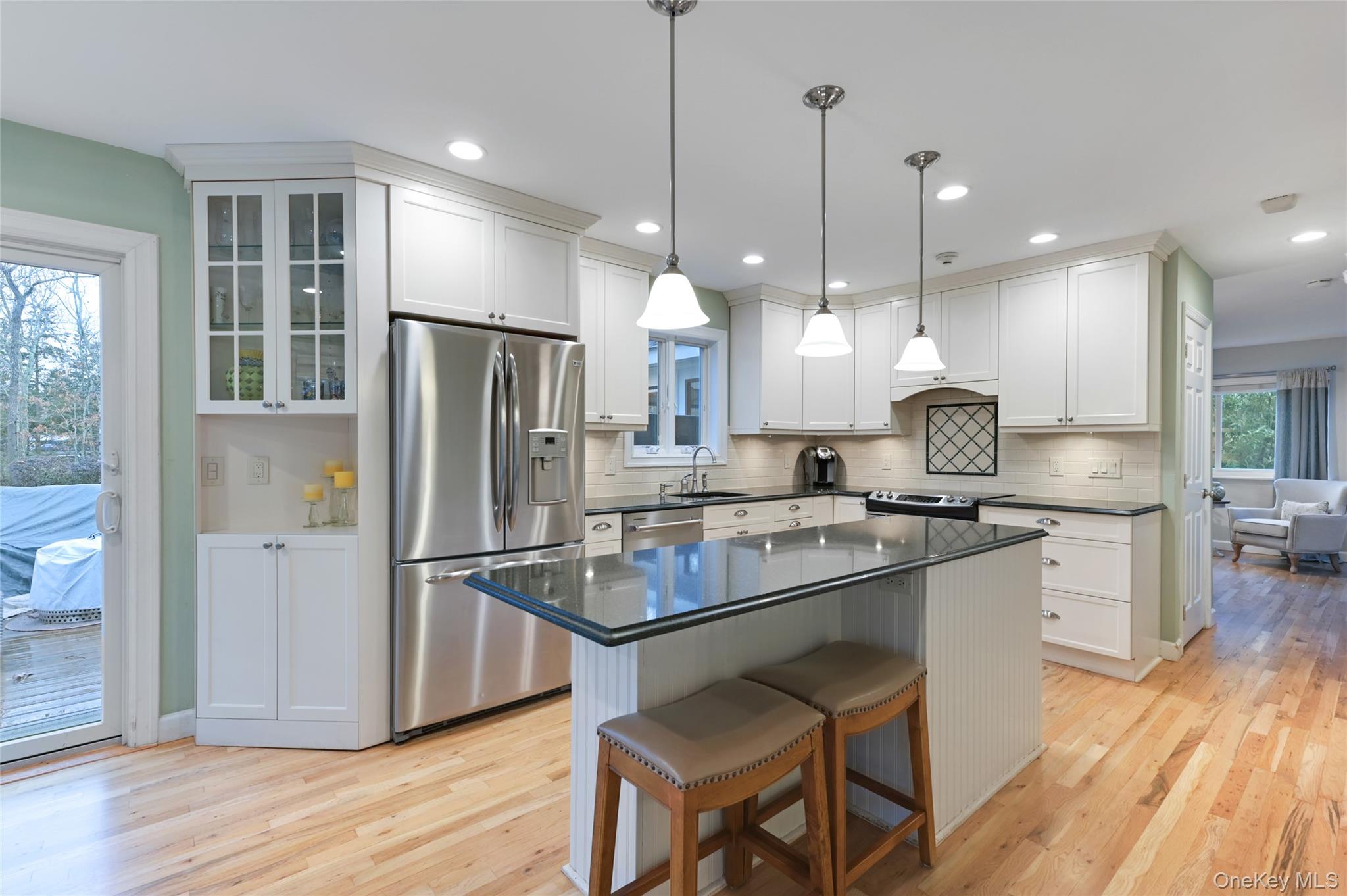 9 North Quarter Road Westhampton, NY 11977 - Photo 10 of 38 a kitchen with kitchen island a refrigerator a stove a sink and a wooden floor