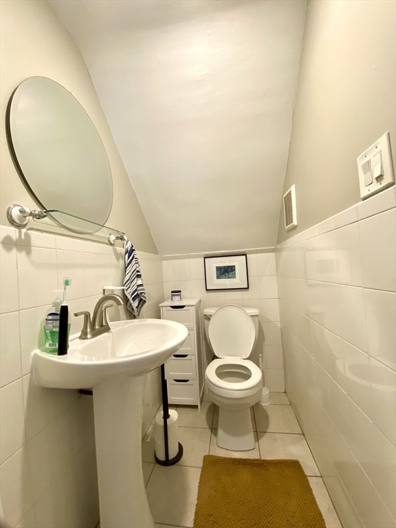 1011 Washington Street, Unit 1 Newton, MA 02460 - Photo 16 of 17 a bathroom with a toilet sink and mirror
