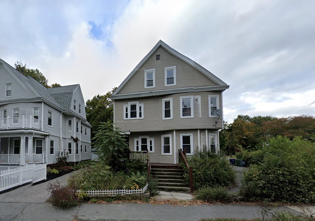 1011 Washington Street, Unit 1 Newton, MA 02460 - Photo 17 of 17 a front view of a house with a yard