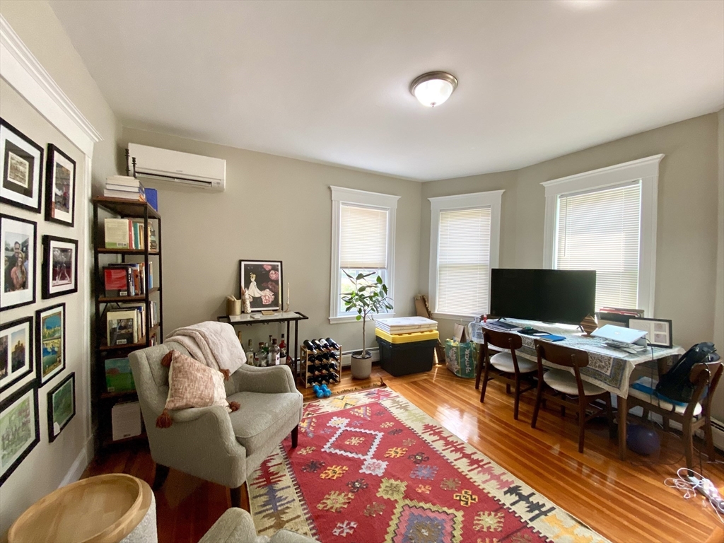 1011 Washington Street, Unit 1 Newton, MA 02460 - Photo 6 of 17 a living room with furniture a rug and a flat screen tv