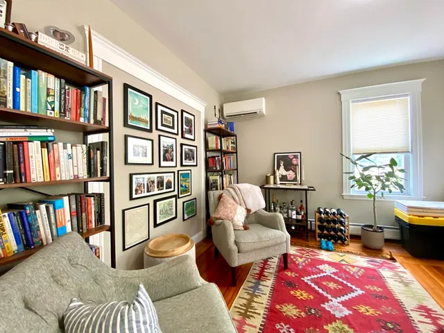 a living room with furniture and a book shelf